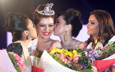 Carey kissed by second runner-up May Salitah and first runner-up Natalia. On the far left is third runner-up Symren Kaur.