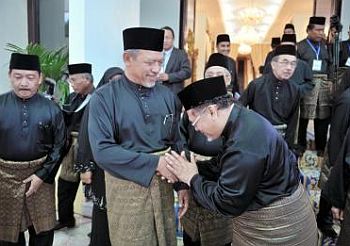 Political transition: Umno is looking forward to a more cordial working relationship with the new Mentri Besar in Kelantan, Datuk Ahmad Yakob, who is seen here shaking hands with his deputy Datuk Nik Amar Nik Abdullah (right) after the swearingin at the Palace. — Bernama
