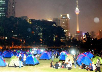 Into the night: Demonstators camping out at Padang Merbok last night.