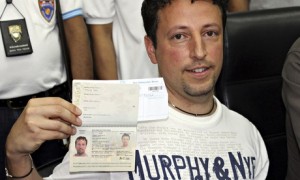 Luigi Maraldi, whose stolen passport was used by a passenger boarding flight MH370, holds his current passport.
