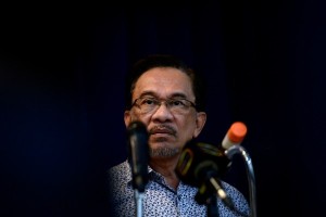 Malaysian opposition leader Anwar Ibrahim listens to a question during a press conference at Parti Keadilan Rakyat (PKR) party's headquarters in Petaling Jaya on December 12, 2014. The Malaysian Insider/Najjua Zulkefl